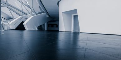 Modern interior with sleek white walls and geometric staircase design.