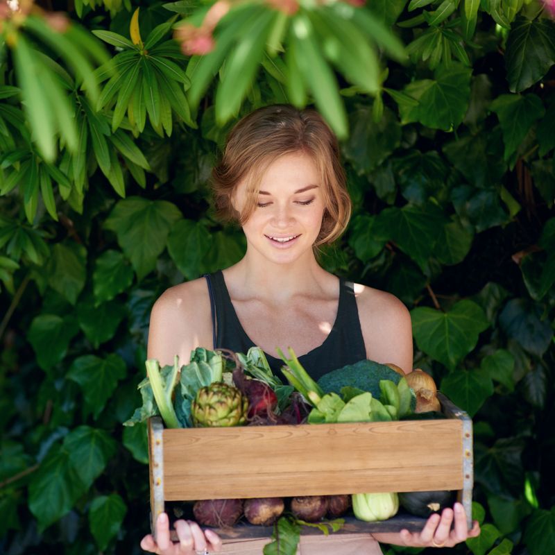 A young woman holding a crate of vegetables outdoorshttp://195.154.178.81/DATA/i_collage/pu/shoots/804546.jpg