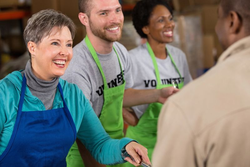 Senior woman volunteering at food bank soup kitchen