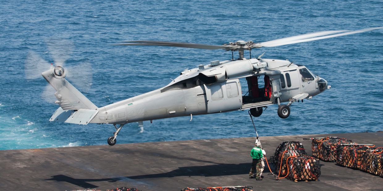 Military helicopter picking up cargo