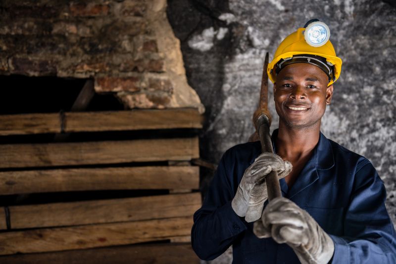 Miner holding a pick axe at the mine