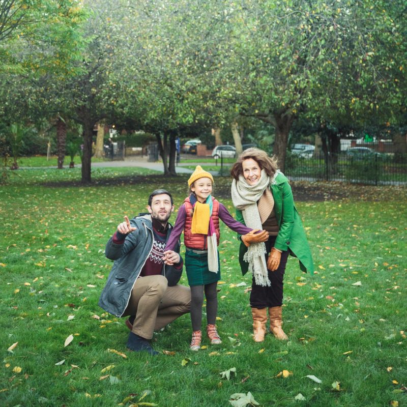 Father and daughter having fun in park in autumn. Photo taken in London, UK.
