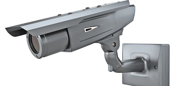 Modern outdoor security camera with a protective cover and adjustable mount.