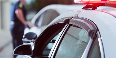 Police car with flashing lights during a traffic stop.