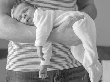 Baby holding and reassurance in arms massage pose 