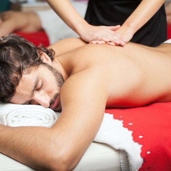 Man receiving a relaxing back massage in a spa.