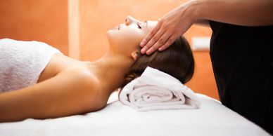 Woman receiving a head massage at a spa.