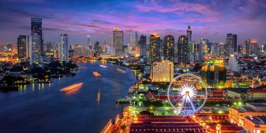 Bangkok city with the river running through it at dusk from the air