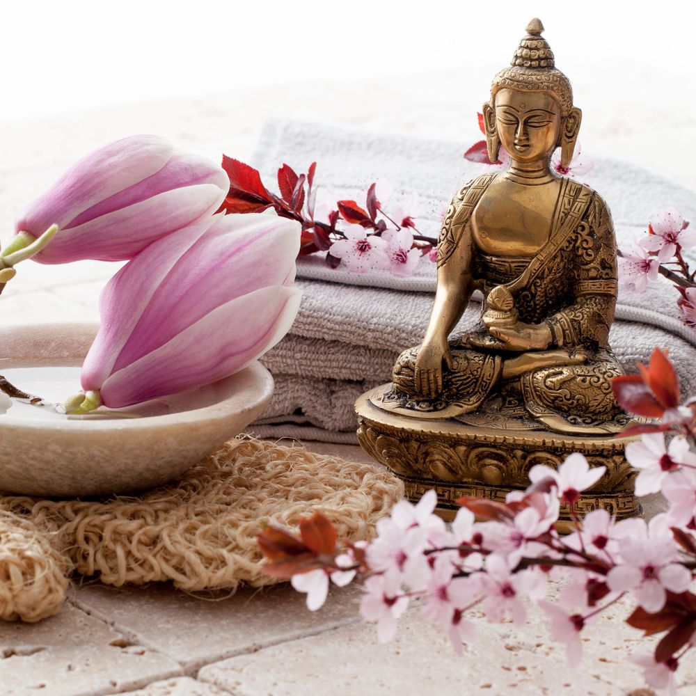Title Bombshell in cursive with a Budda, lilies, a spa feeling. A peaceful knowing.