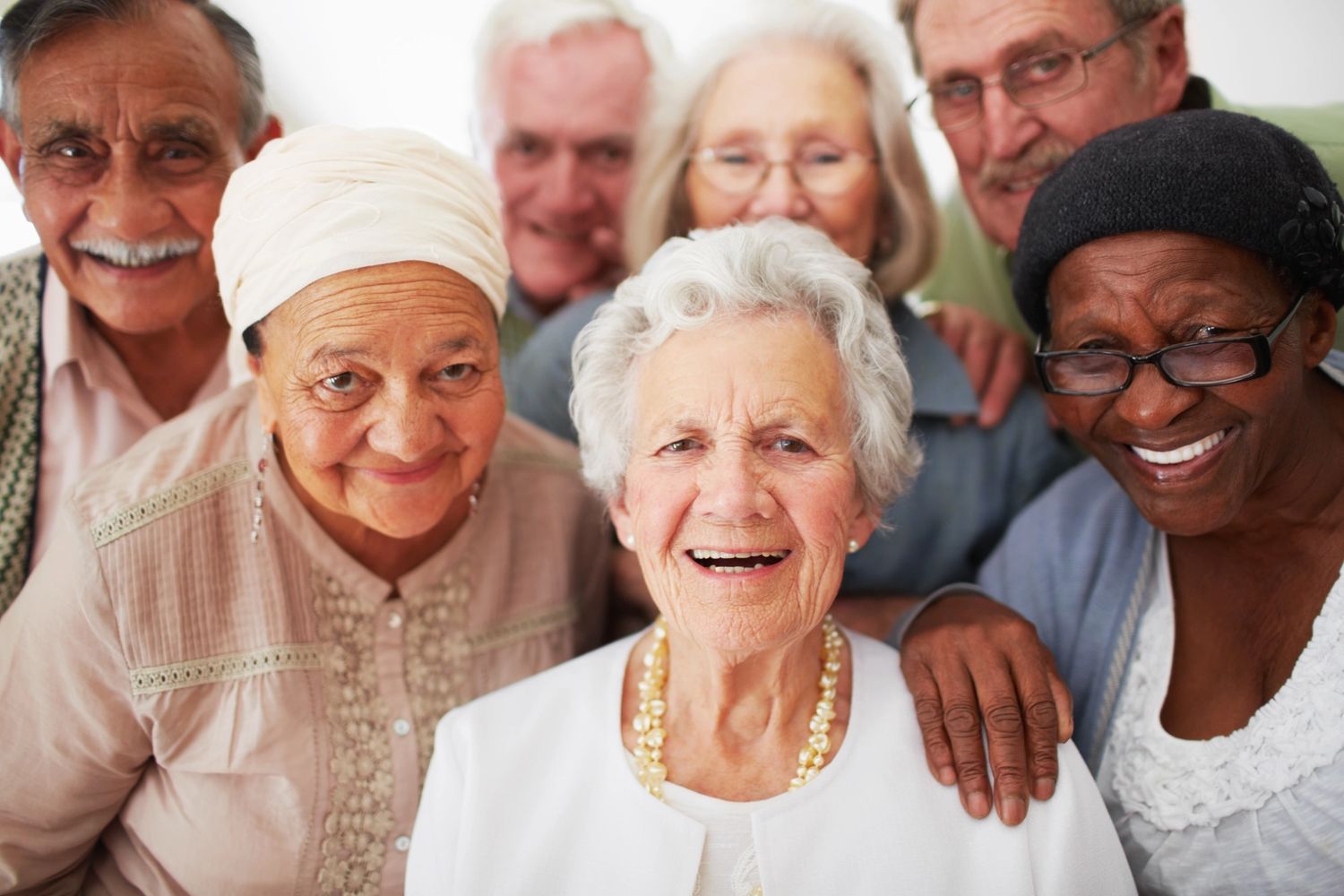 A joyful group of elderly friends smiling together.