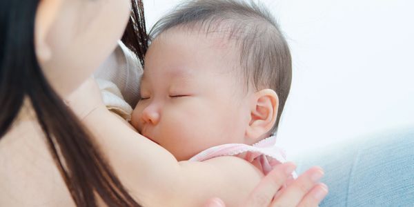 Mother breastfeeding her baby peacefully.