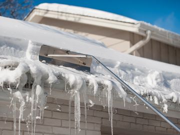 Winnipeg roof raking service removing snow buildup