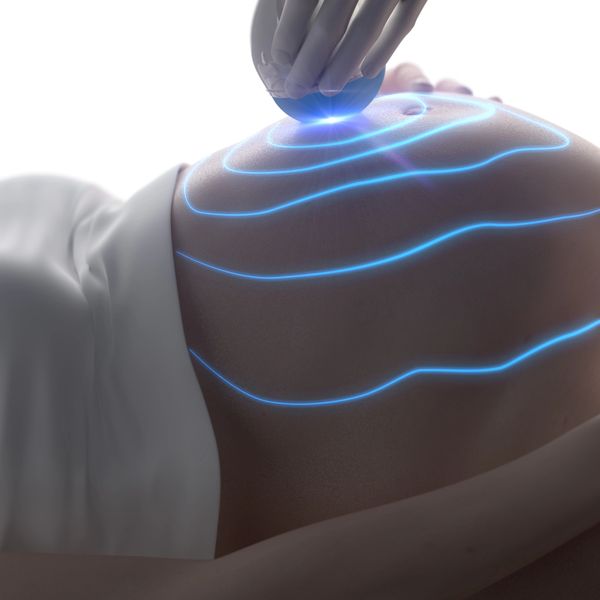 Ultrasound imaging being performed on a pregnant belly with glowing blue waves.