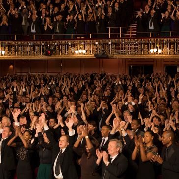 Theater audience cheering.