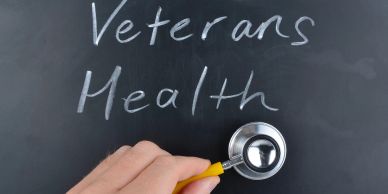 Stethoscope on blackboard with 'Veterans Health' text.