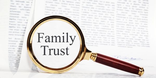 Magnifying glass focusing on the words 'Family Trust'.