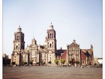 Historic cathedral with twin towers under a clear blue sky.