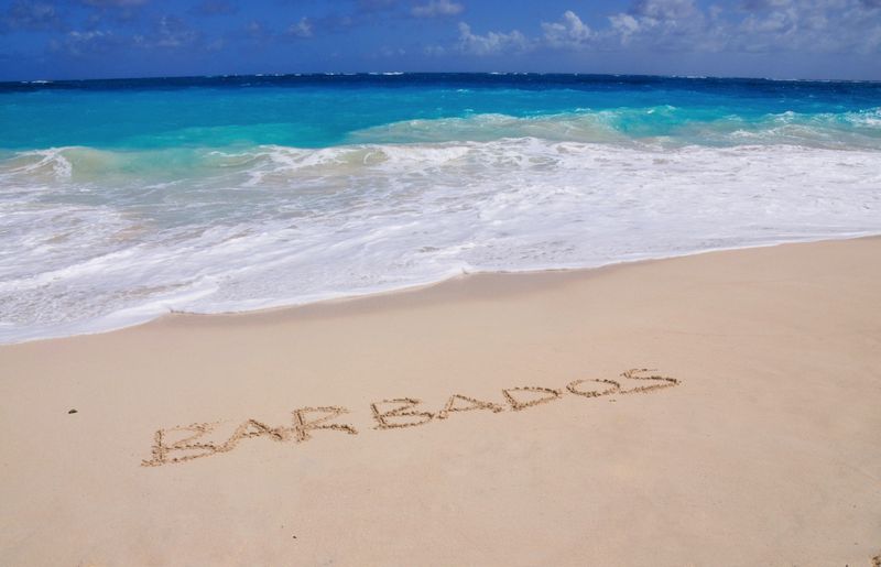 Barbados written in a white sand beach