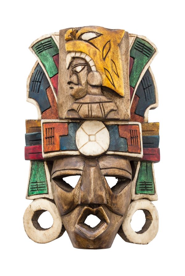 Colorful traditional wooden mask with intricate carvings and bold geometric patterns.