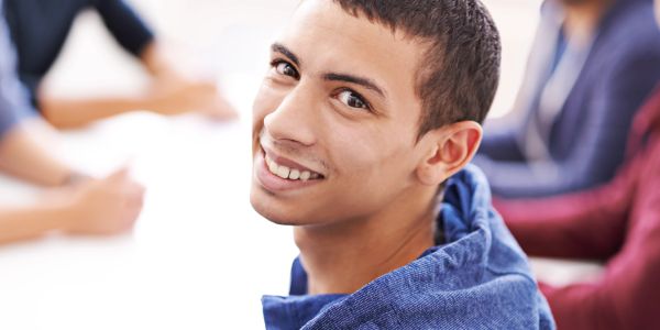 Smiling young man looking at camera.