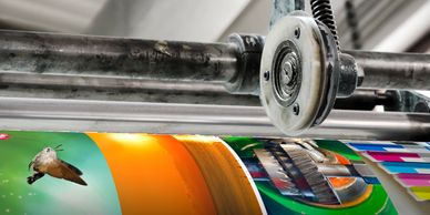 Close-up of printing machine producing colorful images.