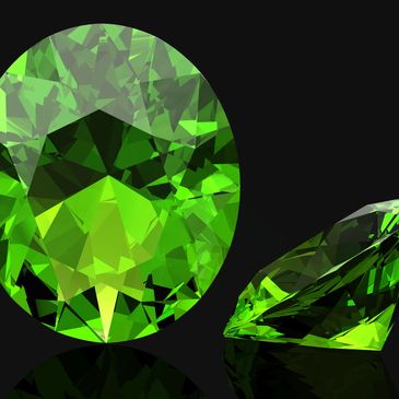 Two vibrant green gemstones with intricate cuts on a black background.