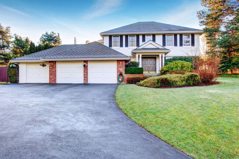 Brock house with greenery, and nice driveway.