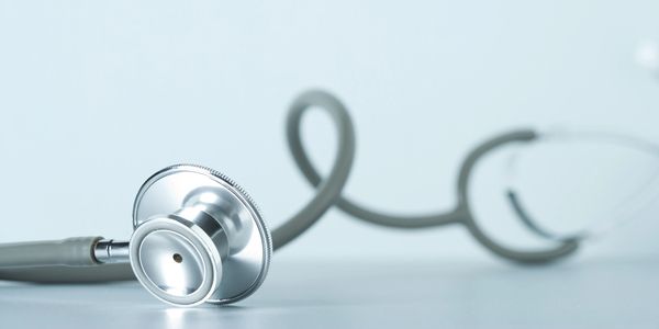 Close-up of a stethoscope on a surface.