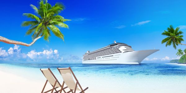 Beach scene with chairs, palm trees, and a cruise ship.