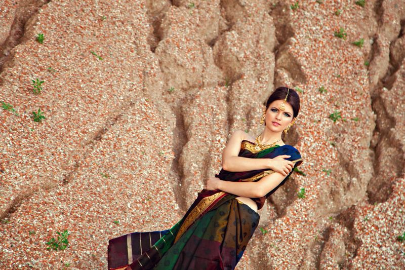 Beautiful girl with oriental make-up, indian sari and indian jewelry