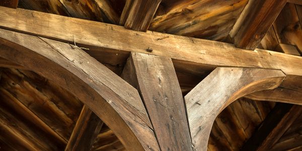 Close-up of wooden roof beams with rustic texture. traditional timber joinery