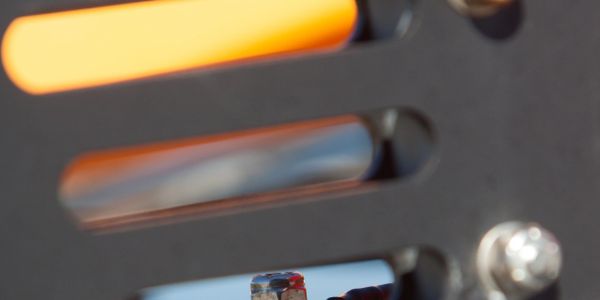 Close-up of a mechanical part with a glowing orange element.
