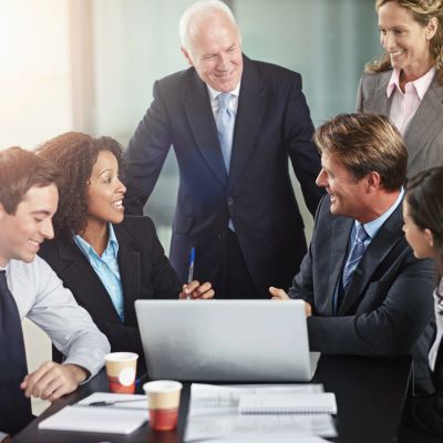 Business team having a meeting around a laptop.