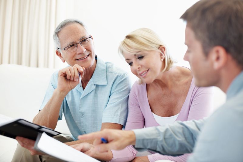 A mature couple talking to their financial advisor