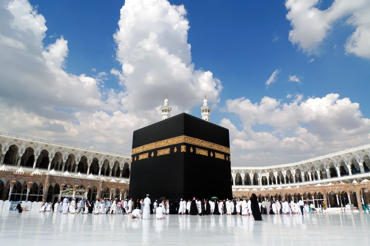 The Kaaba in Mecca with pilgrims around it under a bright sky. A number of these pilgrims would be reverts performing Umrah