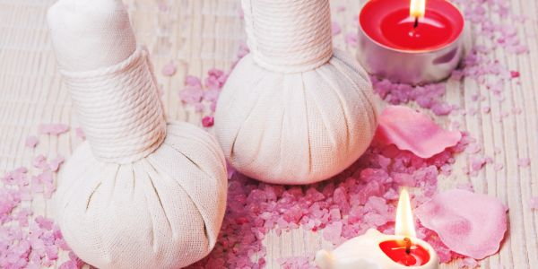 Spa setting with herbal compress balls and candles.