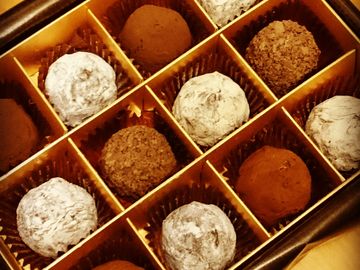Assorted chocolate truffles in a divided box.