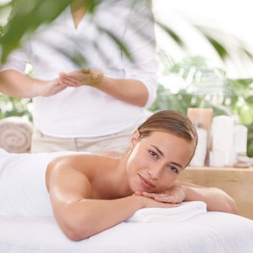 A woman enjoys a relaxing massage in a serene spa setting.