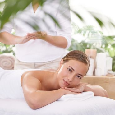 Woman relaxing during a spa massage session.