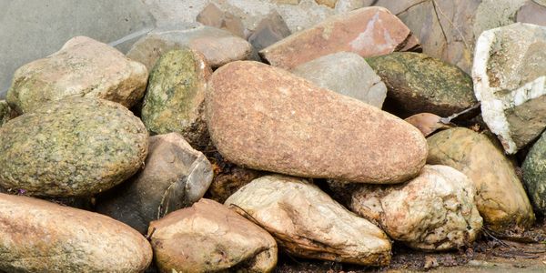 A collection of variously shaped and colored rocks piled together.