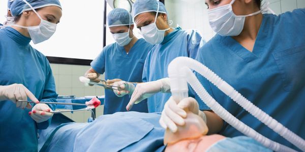 Surgical team performing an operation in a sterile operating room.