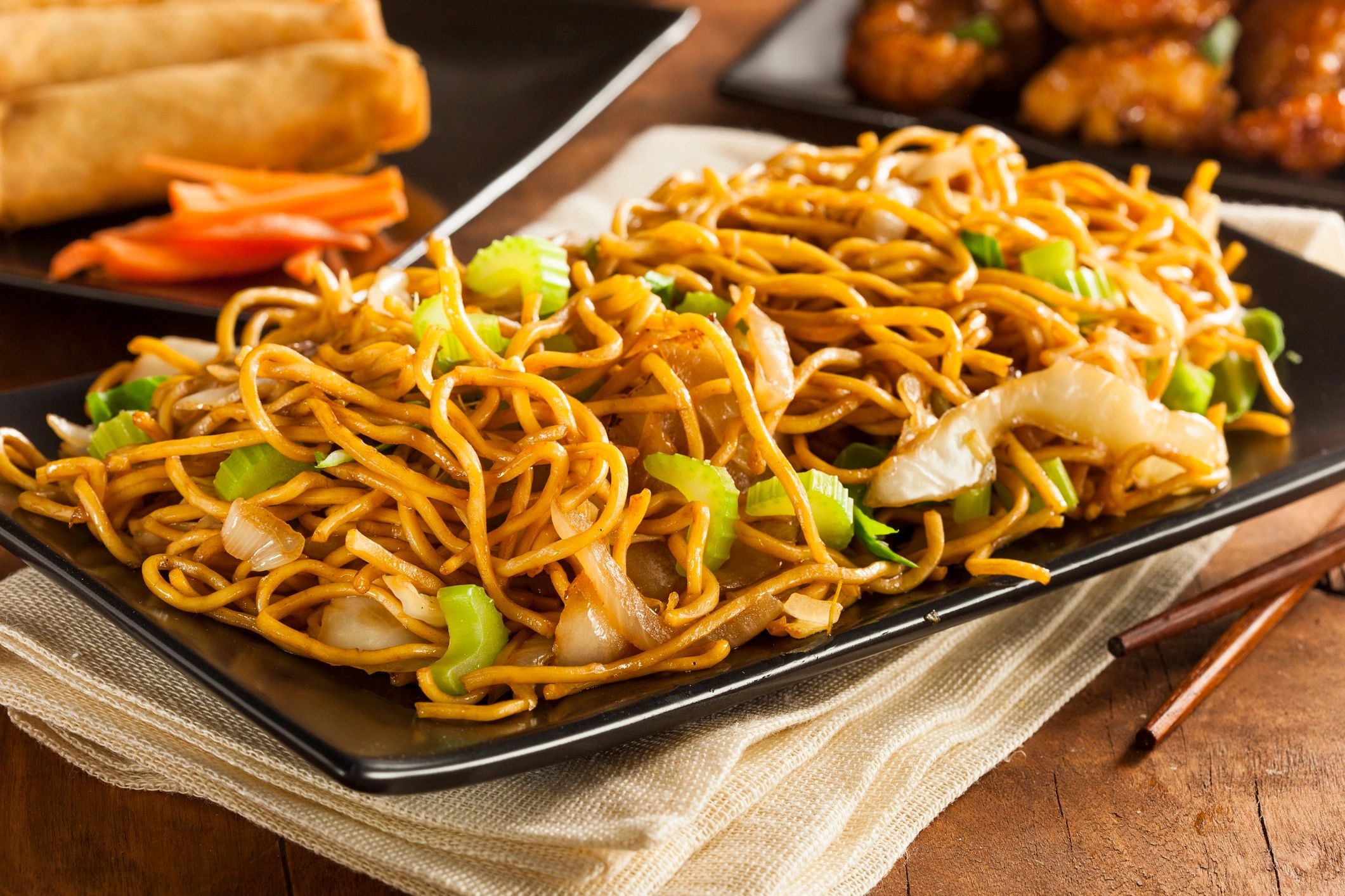 Plate of Asian stir-fried noodles with vegetables.