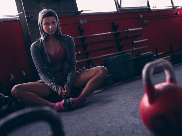 Fit woman showing strong back muscles in a gym setting.