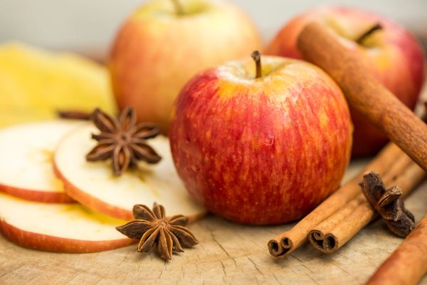 Red apples with cinnamon sticks and star anise.