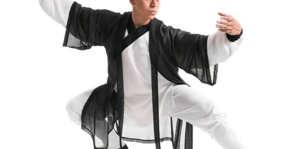 Person practicing a martial art in traditional black and white attire.