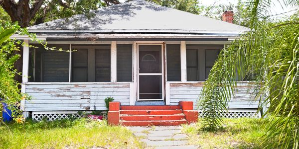 A house with steps leading to the front door.