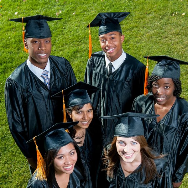 Group of happy graduates in caps and gowns.