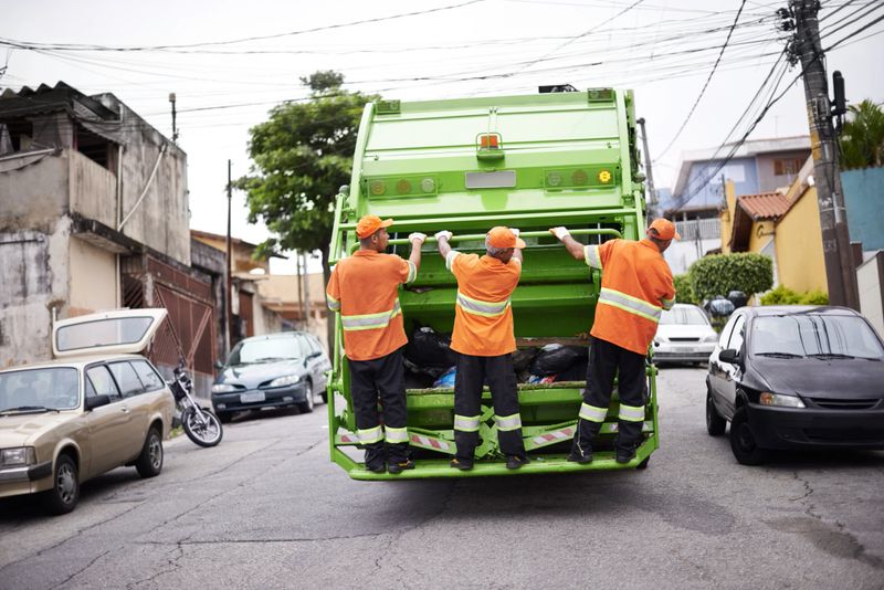 Cropped shot of a garbage collection team at work