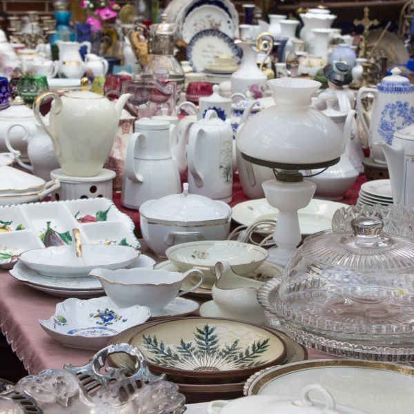 Table filled with diverse ceramic and glass dishes and containers.