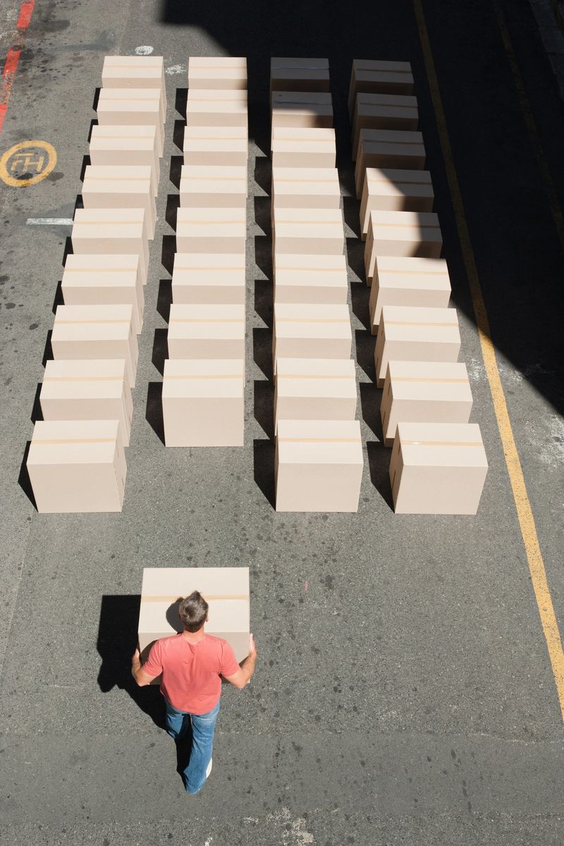 Man carrying box in roadway